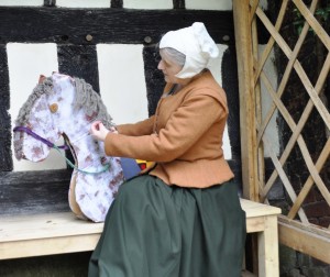 1 Tudor Gentlewoman Alison Nicholls grooms a hobby horse at Little Moreton Hall C Alan Ingram National Trust